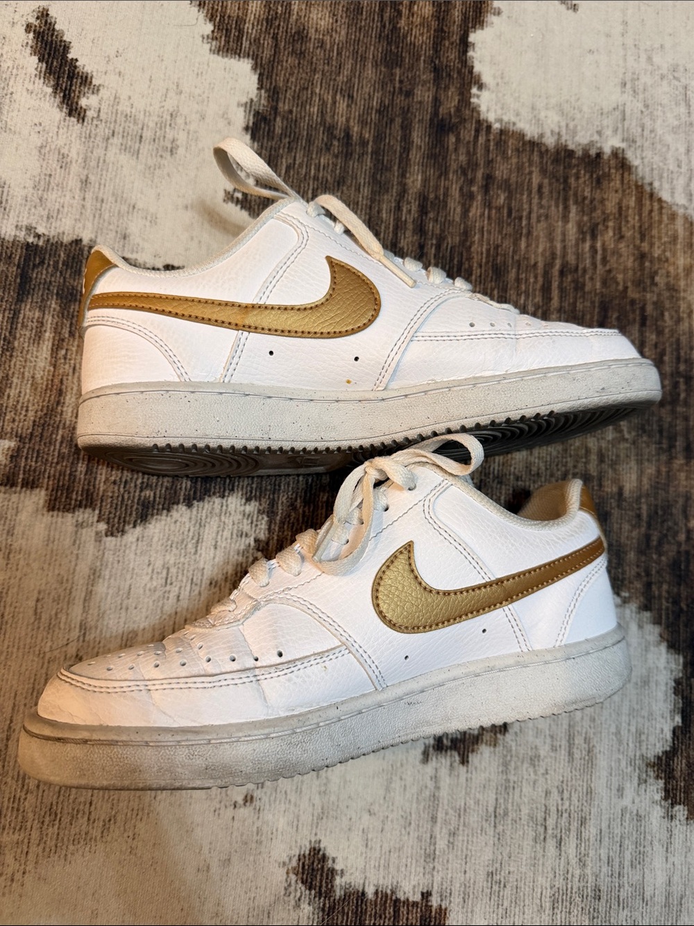 Women’s Nike White Sneakers with Gold Swoosh
